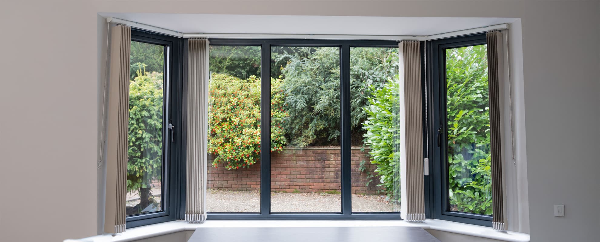 An aluminium casement bay window seen from inside a bright room