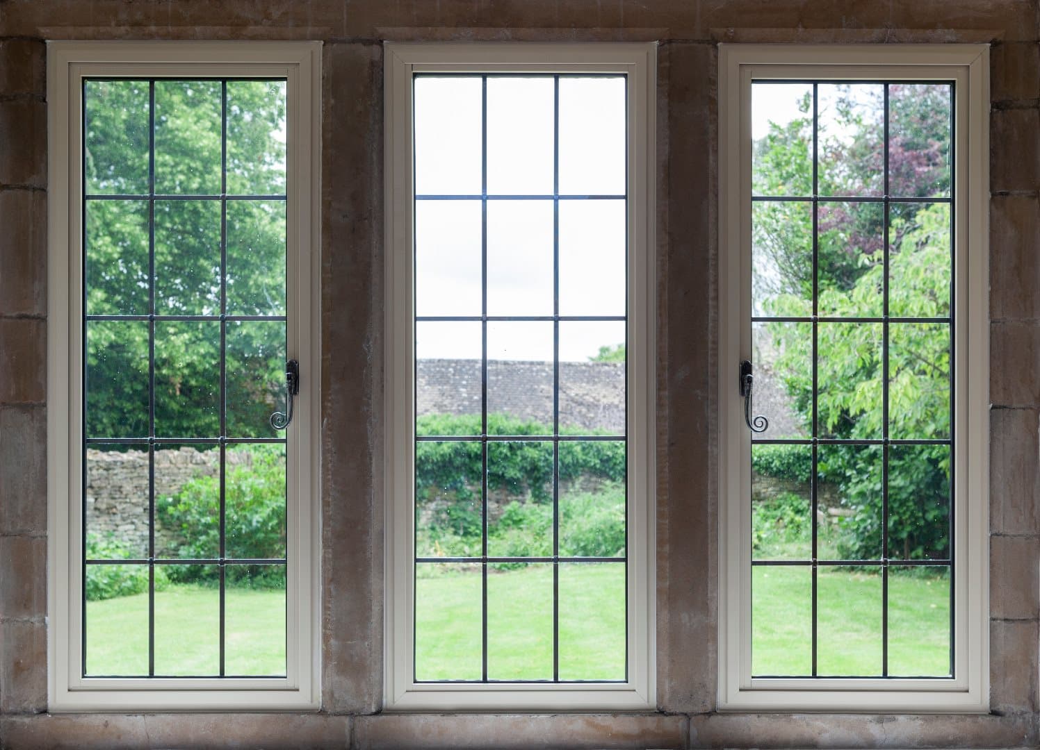 A leaded triple casement window set in an old stone wall