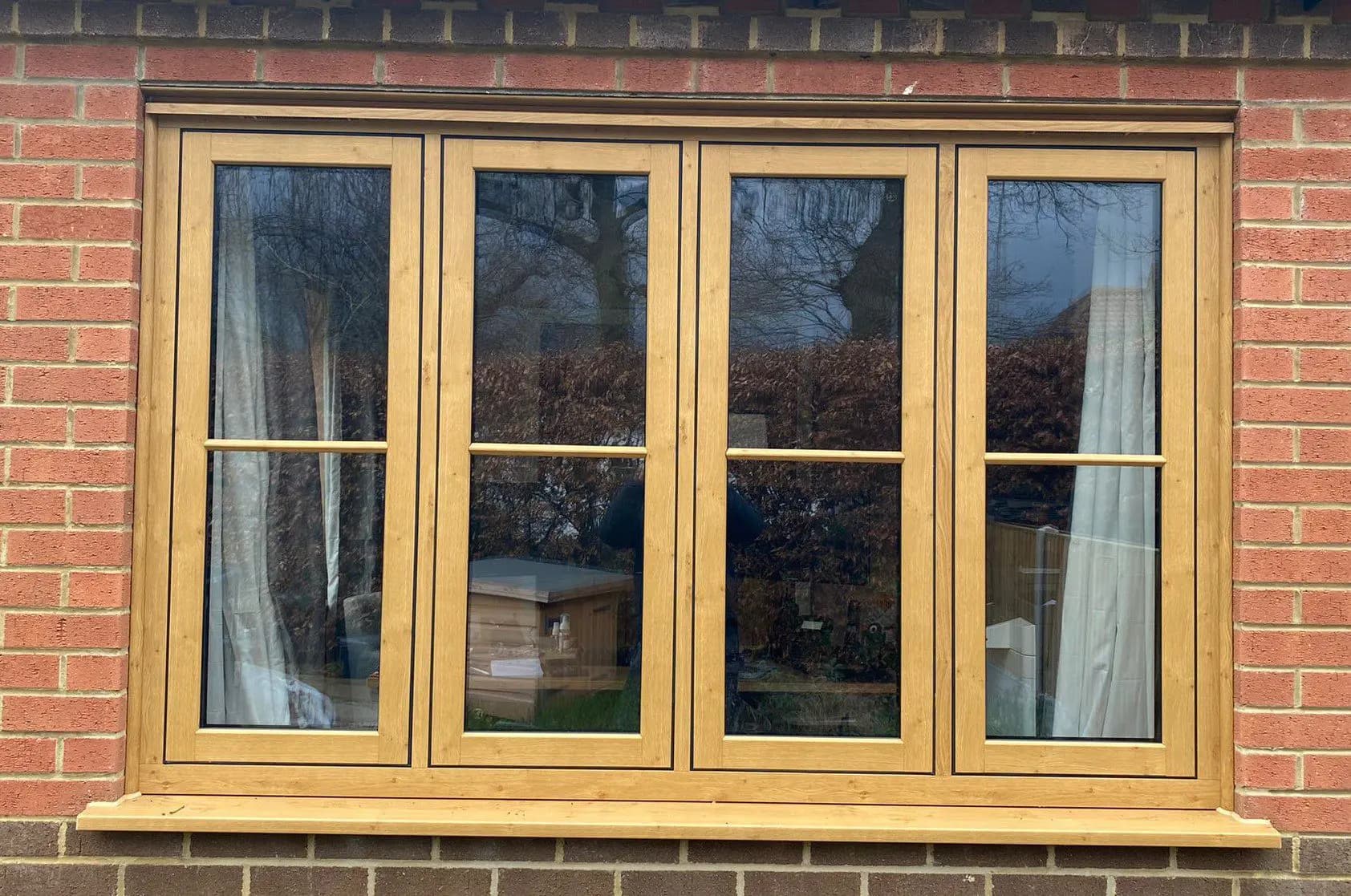 Irish Oak woodgrain flush casement windows in a brick elevation