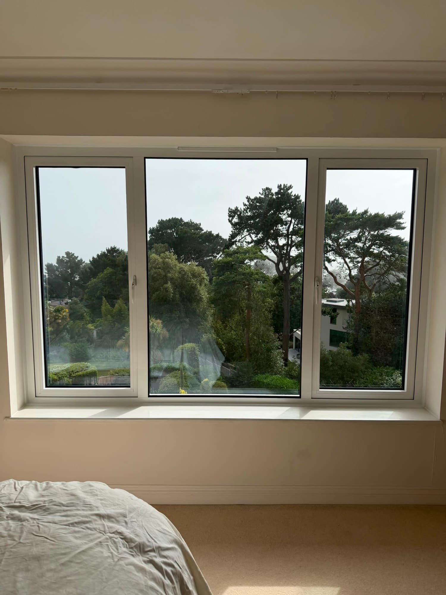A white uPVC casement window in an arched brick opening, a real Wilshaw installation