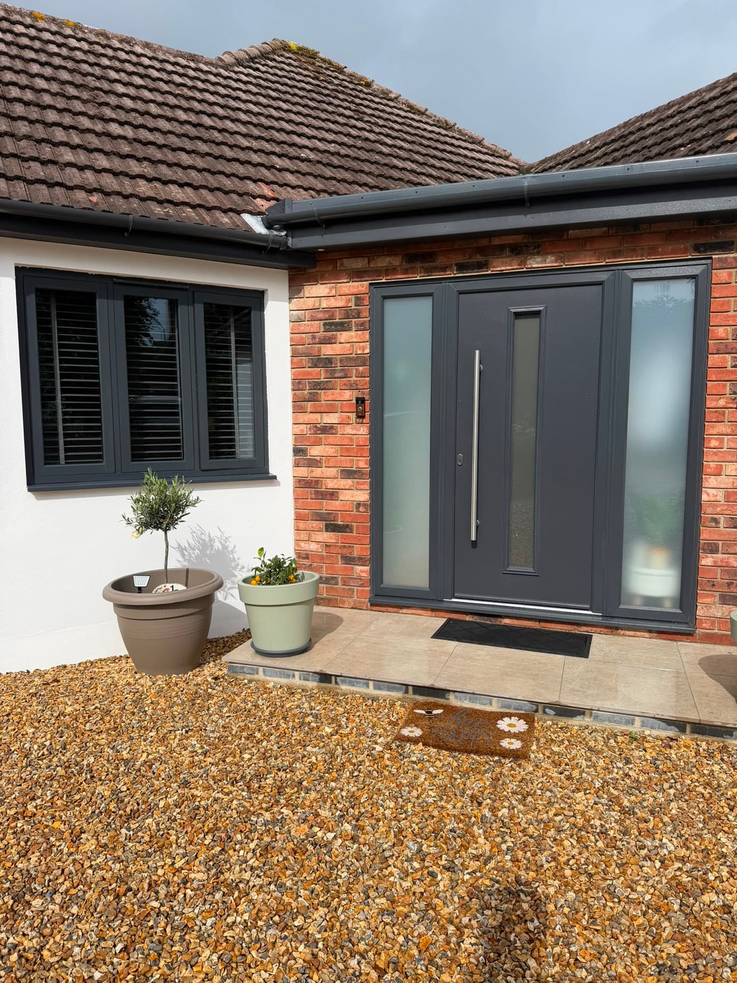 An anthracite composite front door with two obscure-glazed sidelights, a real Wilshaw installation