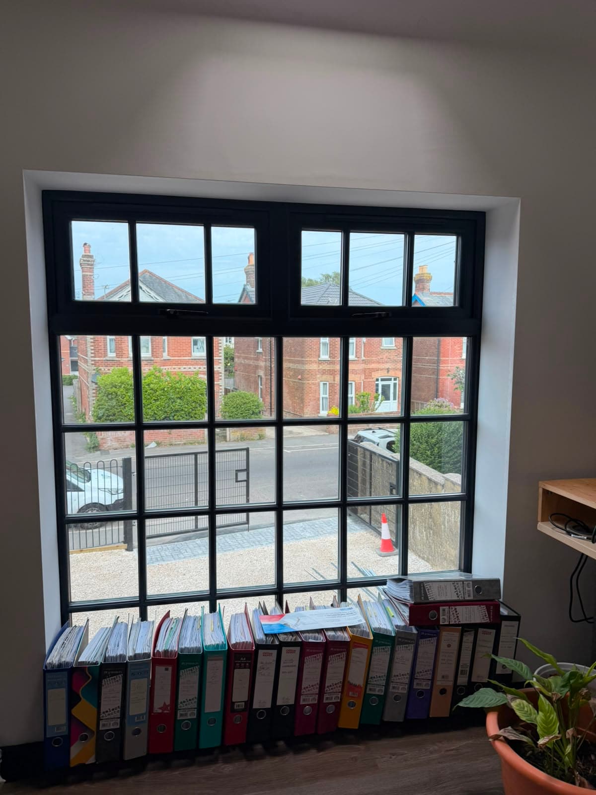 Slim anthracite aluminium heritage windows seen from inside a bright room, fitted by Wilshaw Glazing