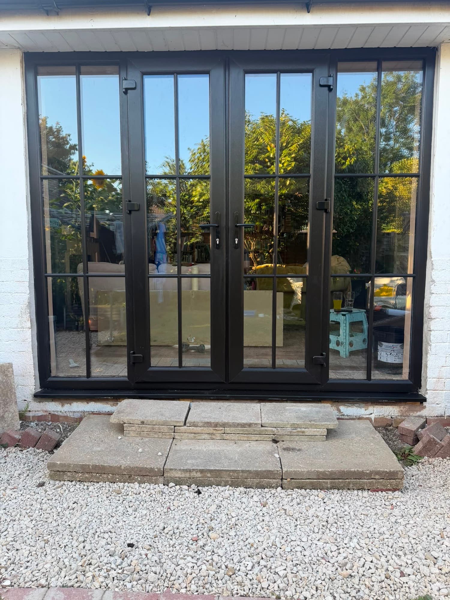 Black aluminium French doors with Georgian bar glazing, fitted by Wilshaw Glazing
