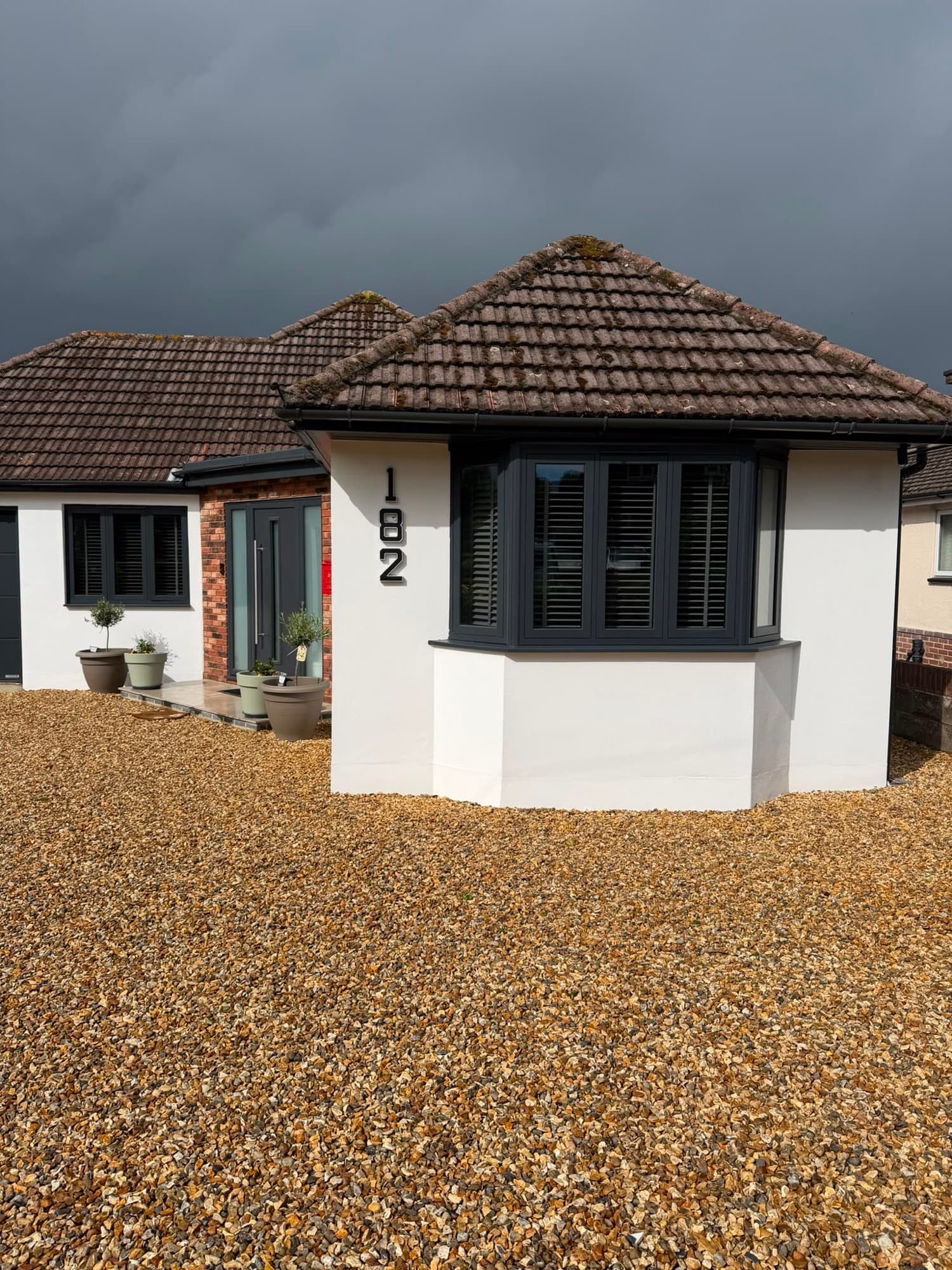 A bay fitted with anthracite timber-look flush casement windows, one of our own installations