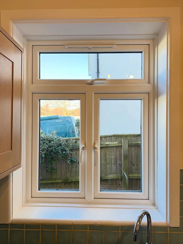 A white uPVC casement window seen from inside a kitchen, a real Wilshaw installation